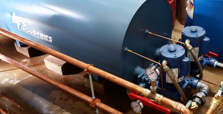 A large blue commercial water heating tank in a utility room.