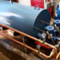 A large blue commercial water heating tank in a utility room.